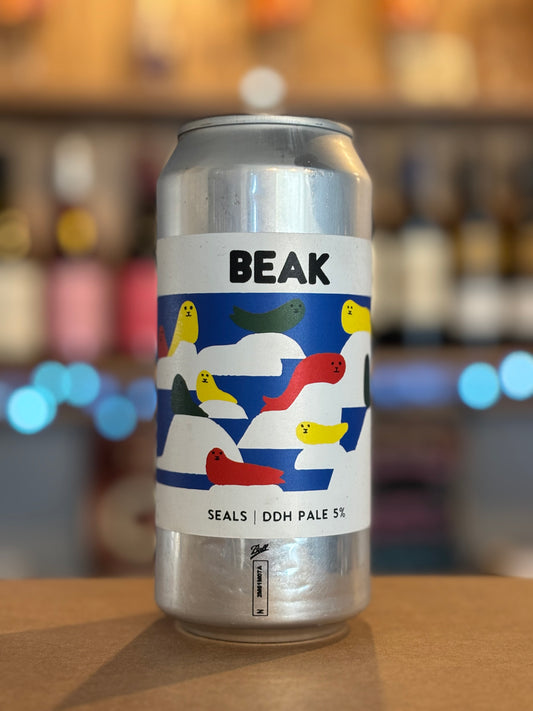 Silver can with colorful label featuring the brand 'BEAK' on a blurred bar background.