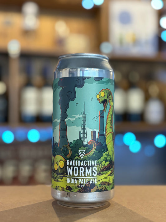 Beer can labeled 'Radioactive Worms' on a bar counter with blurred shelves in the background