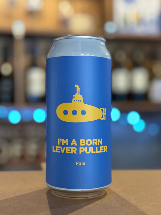 Blue beer can with yellow submarine graphic and text on a blurred bar background