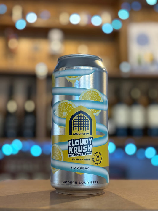 Can of Vault City Cloudy Krush beer on a bar counter with a blurred bar background