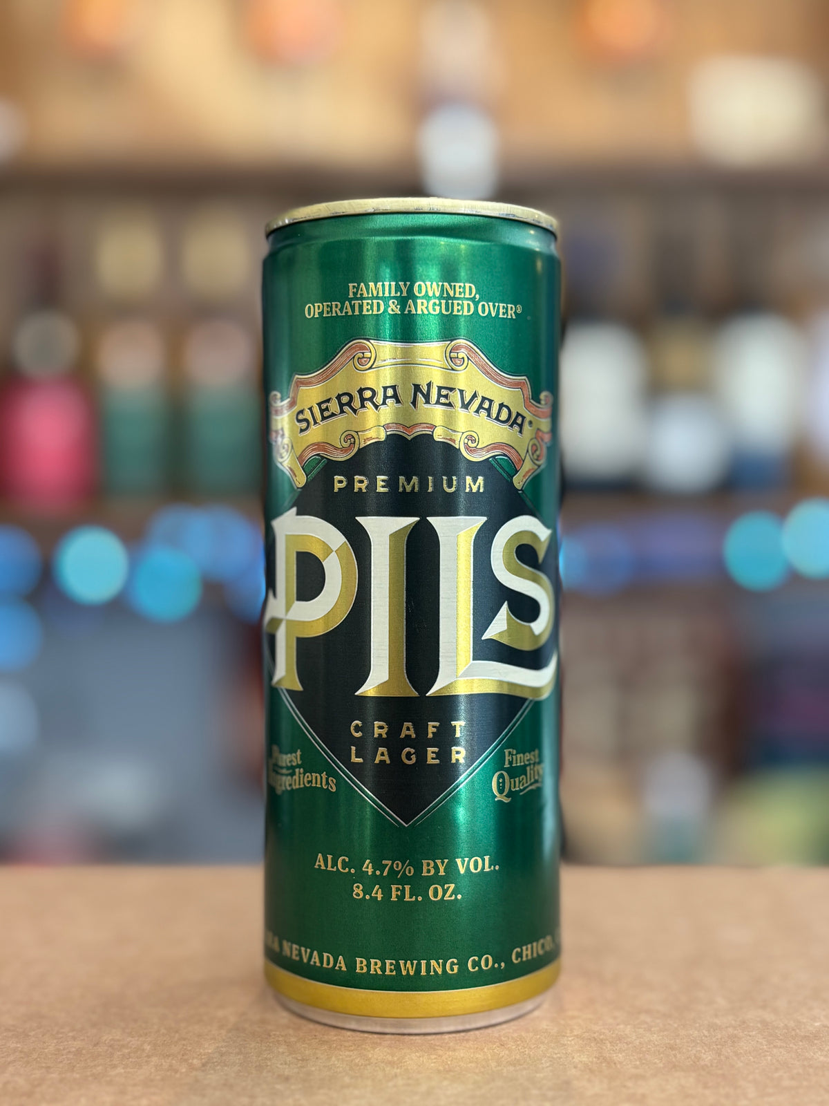 Sierra Nevada Pils can on a bar counter with a blurred bar background
