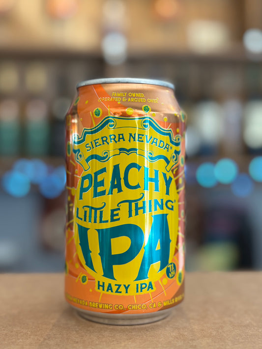 Can of Sierra Nevada Peachy Little Thing IPA on a wooden surface with a blurred background