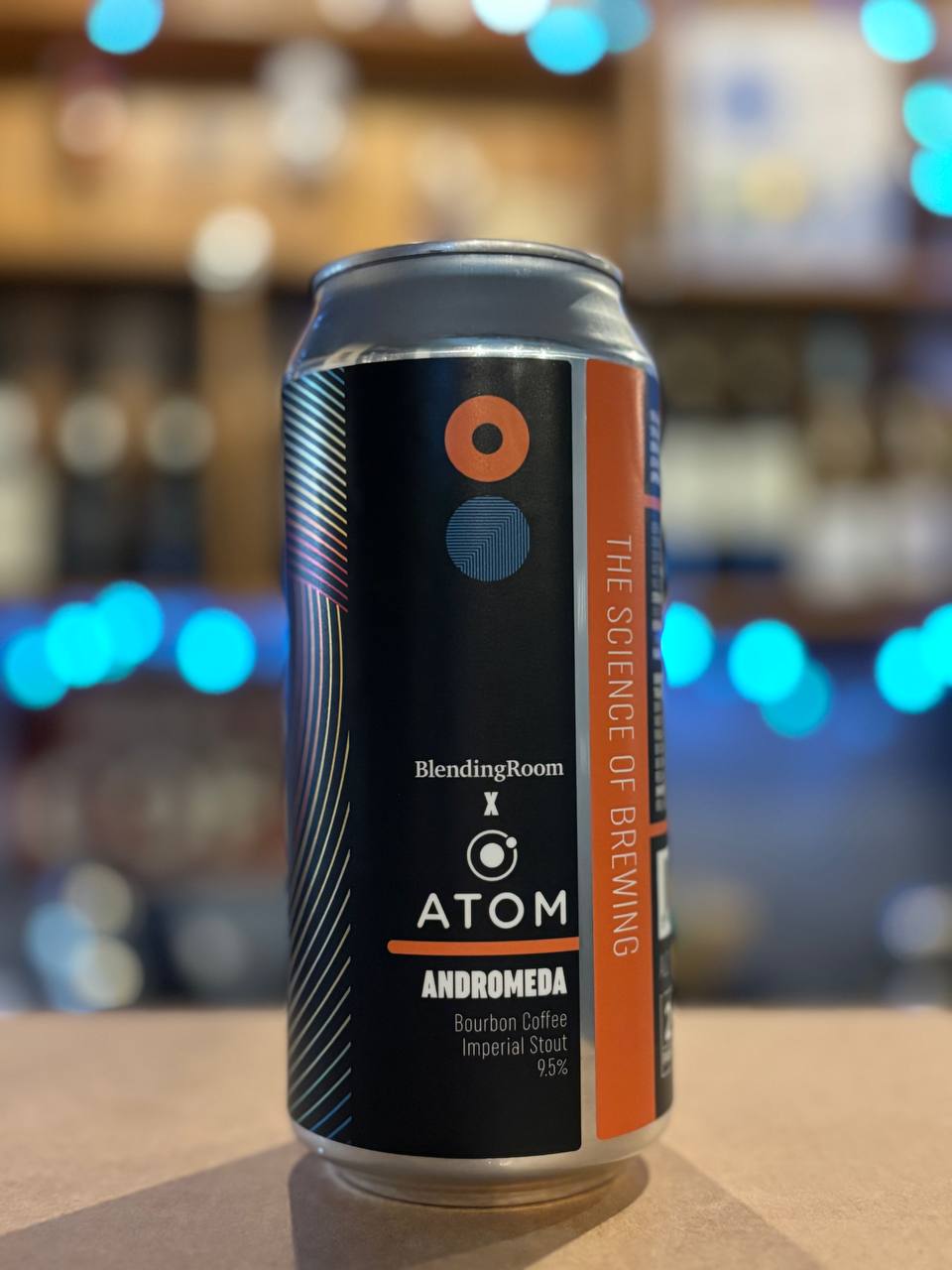 Can of Atom Blending Room Andromeda beer on a bar counter with a blurred bar background